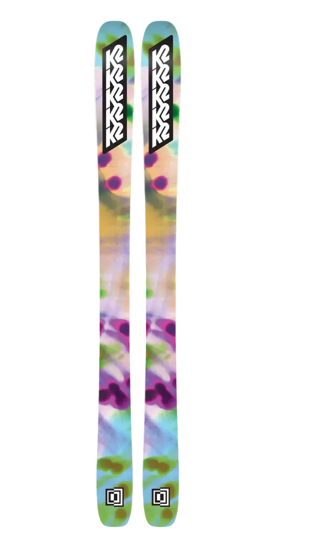 K2 Mindbender 96C W alpine skis with bindings, showcasing a sleek design and vibrant graphics on a snowy background.